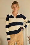 Woman wearing a striped sweater with a neutral background