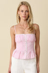Woman wearing a pink and white striped top against a beige background
