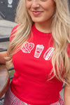 Woman wearing a red t-shirt with food graphics outdoors